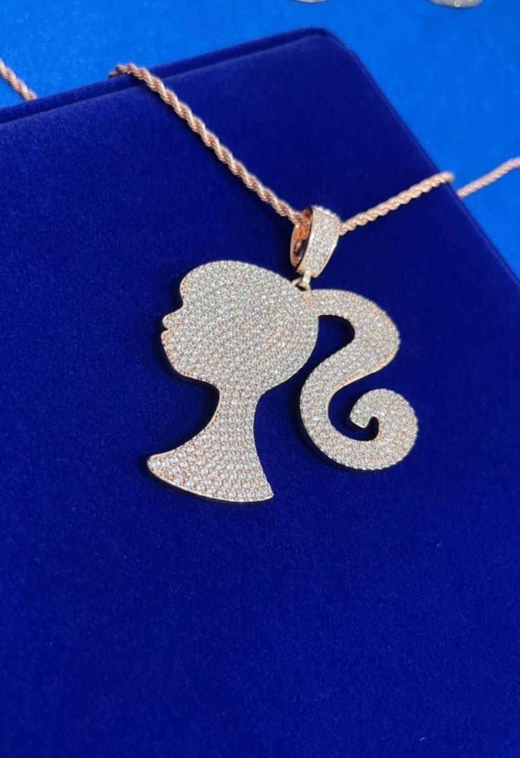 Image of iced out doll pendant in rose gold.